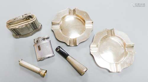 A pair of modern silver ashtrays, two metal lighters, a silv...