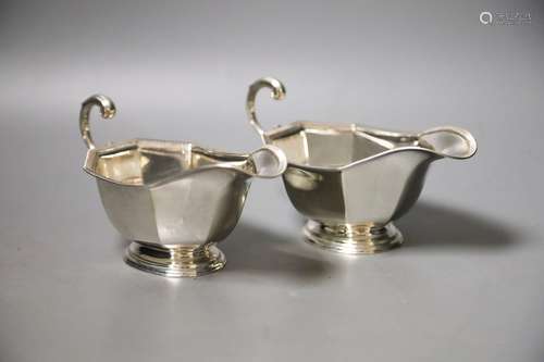 A pair of 1930's silver sauceboats, with flying scroll handl...