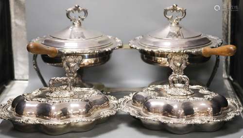 A pair of cast plated shaped oval entree dishes and covers a...