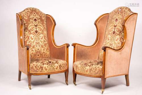 A pair of Edwardian satinwood banded mahogany wing armchairs...