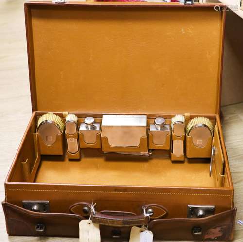 A 1930's Harrods pigskin travelling toilet case with seven e...