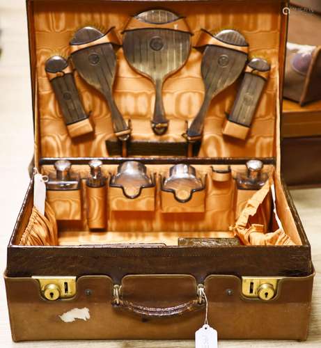 A George V crocodile skin travelling toilet case with ten en...