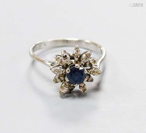 An 18ct white metal, sapphire and diamond set flower head cl...