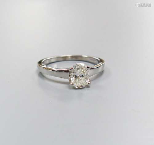 A modern 18ct white gold and solitaire oval cut diamond ring...