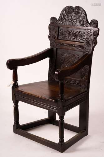 A 17th century Yorkshire area carved oak wainscot chair, wid...