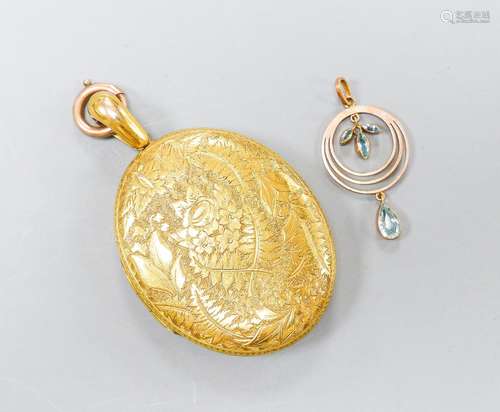 A Victorian engraved yellow metal oval locket, with engraved...