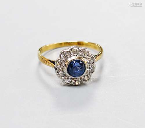 A yellow metal, sapphire and diamond cluster set flower head...