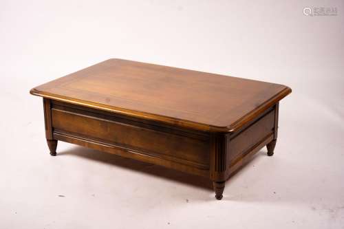 A reproduction rectangular walnut coffee table with rising t...