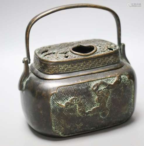 A Chinese bronze hand warmer, Xuande mark to base, old repai...