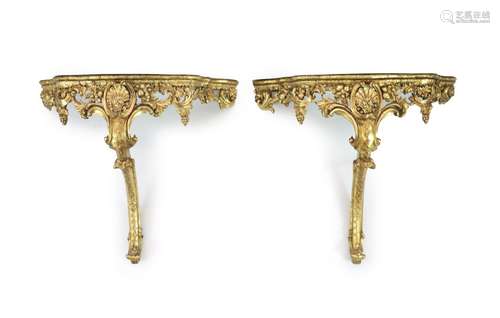 A pair of Louis XV style carved giltwood console tablesWith ...