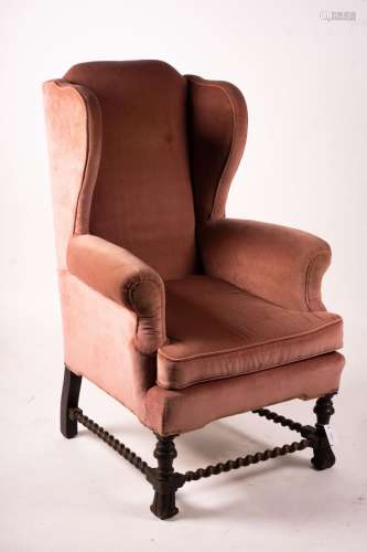 An early 20th century Jacobean revival upholstered wing armc...