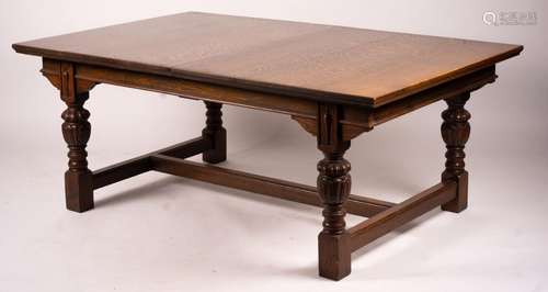 A 17th century style carved rectangular oak extending dining...