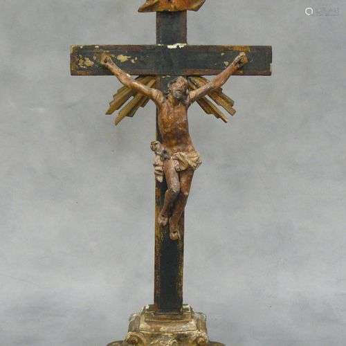 un crucifix baroque en bois sculpté polychrome, la base à dé...