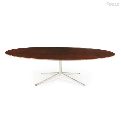 An oval top wood table on a chrome base, '70s