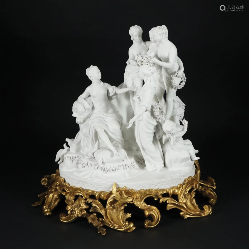 A French biscuit group on a chiseled gilt bronze base
