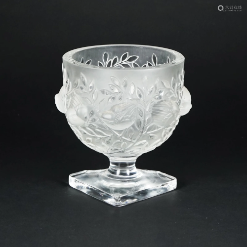 A crystal cup with birds