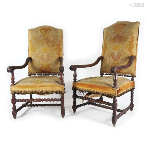 A pair of French carved oak large armchairs