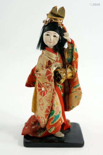 A Japanese doll dressed in traditional Japanese