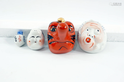 A set of Japanese masks made of porcelain, including a