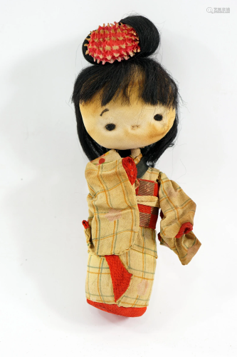 A Japanese doll made of wood and fabric 18 cm high