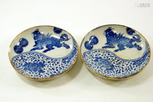 A pair of handmade Japanese saucers drawing a dragon