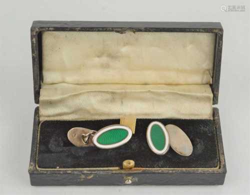 A pair of silver and green enamelled oval form cuff links, i...
