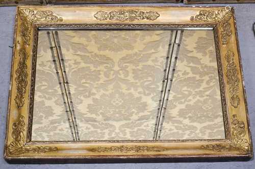 An antique giltwood wall mirror, with decorative composition...