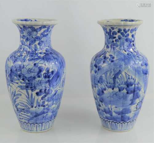A pair of Chinese blue and white vases with floral decoratio...
