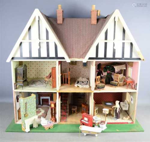 A vintage handmade dolls house complete with electric lighti...