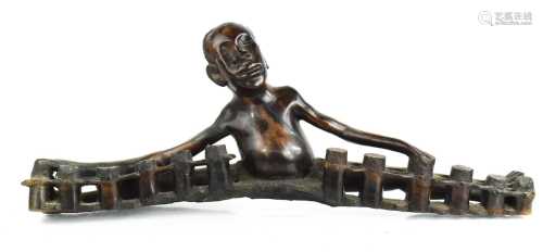 An African carved figure of a boy playing the drums, 62cm lo...