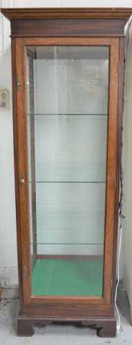 A 20th century oak display cabinet, with glass shelves and i...