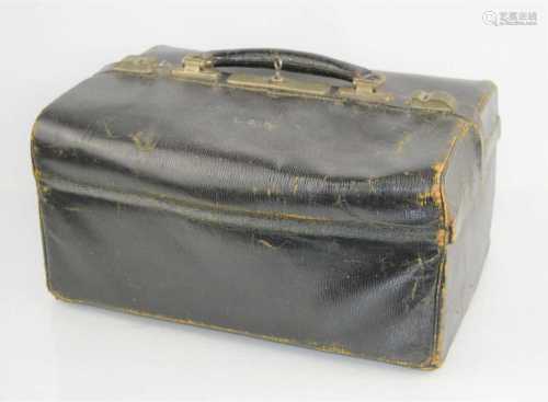 A vintage black leather doctors bag with green felt and fabr...