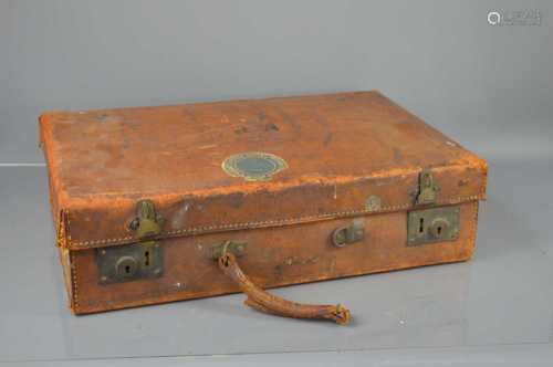 A vintage leather suitcase, bearing initials MP to the top.