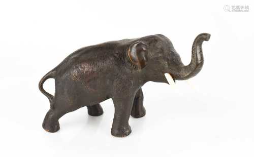 A 19th century bronze elephant with ivory tusks, bearing Chi...