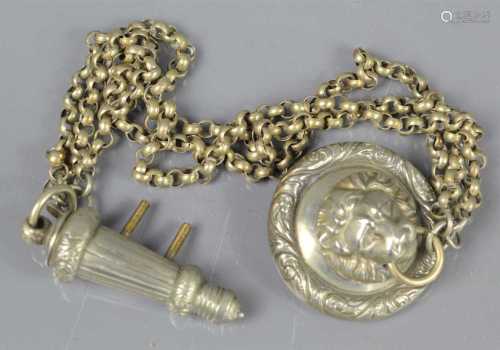 A Victorian lion headed cross belt whistle and chain