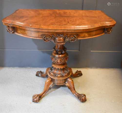 A fine VIctorian rosewood card table with carved decoration ...