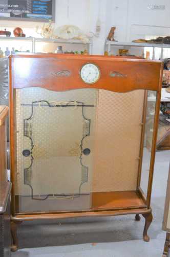 A mid 20th century display cabinet, the top with Smiths cloc...