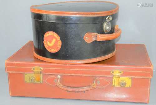 A vintage leather suitcase together with a vintage hat box w...