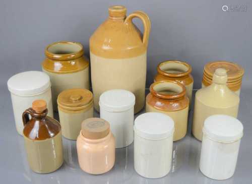 A group of stoneware apothecary jars and flagon