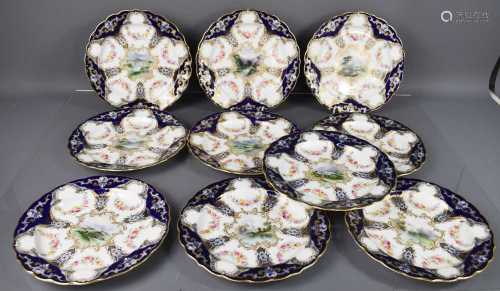 A set of eleven Royal Worcester plates, decorated with a cen...
