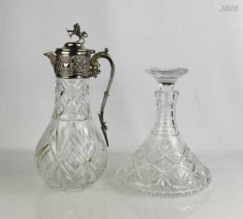 A silver plated and cut glass claret jug with lion and sheil...