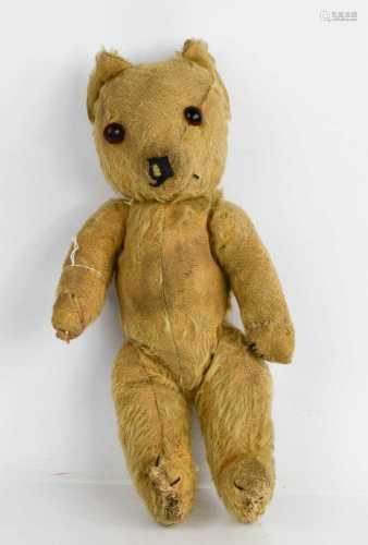 An early 20th century teddy bear, bearing makers button to t...