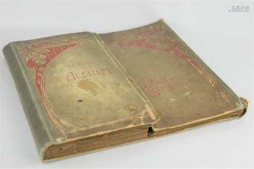 An Edwardian postcard album with various postcards to includ...