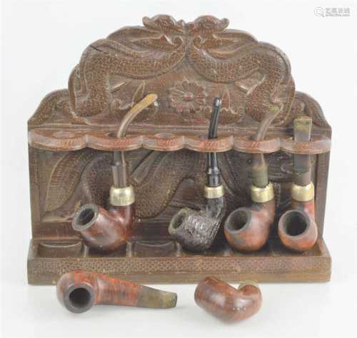 An Oriental dragon design wooden smoking pipe rack together ...