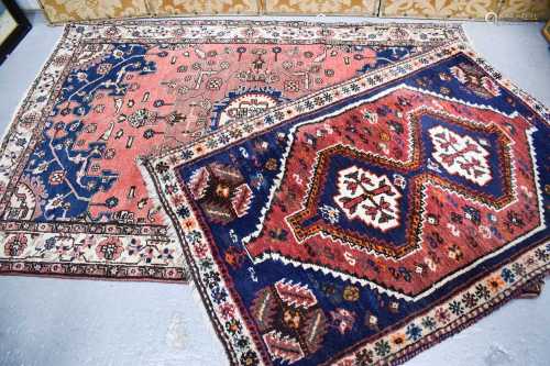 Two Middle Eastern rugs, one wool example with a red and blu...