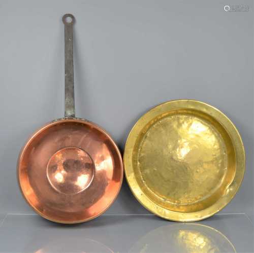A 19th century copper and cast iron pan together with a bras...