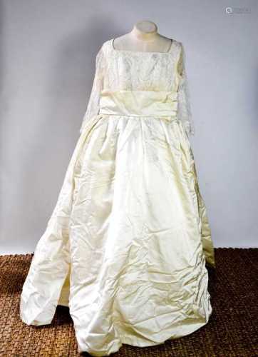 A silk and lace vintage wedding dress, with long sleeves.
