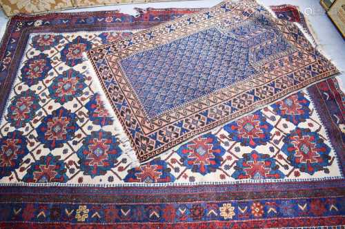 A Middle Eastern rug, the larges having a cream ground with ...