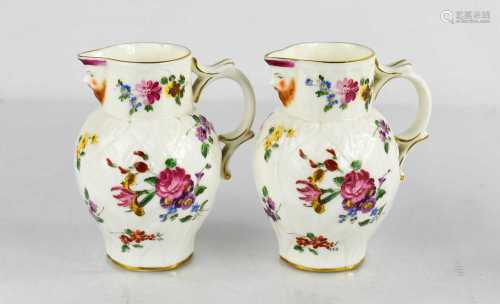 A pair of Royal Worcester leaf moulded jugs with painted ros...