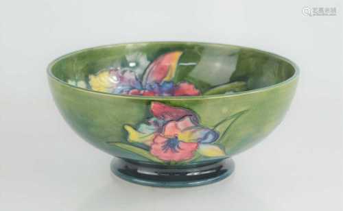 A Walter Moorcroft bowl in the Orchid pattern, signed to bas...